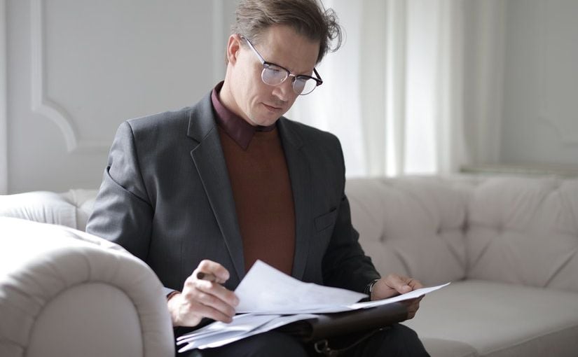 Title image for Employer Recordkeeping Requirements showing an employer reviewing important business' documents.