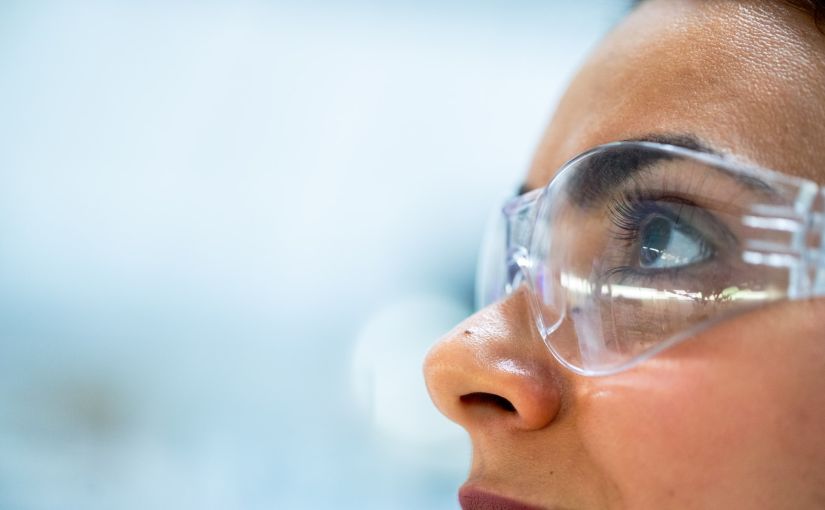 Title image for Return-to-Work Program showing a woman using protective construction glasses.